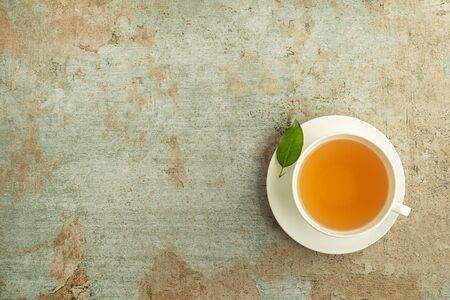 Tea cup. Cup of green and herbs tea served with fresh leafの写真素材