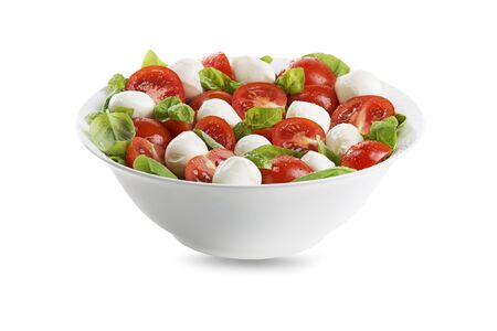 Delicious caprese salad with ripe tomatoes and mozzarella cheese with fresh basil leaves. Italian food. の写真素材