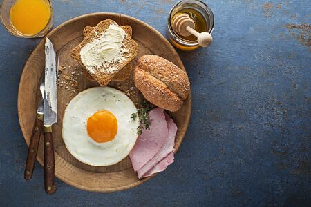 Breakfast meal of fried egg and ham on table top view. Healthy breakfast food.