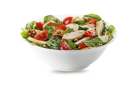 Healthy green salad with chicken breast, tomato and nuts isolated on whiteの写真素材