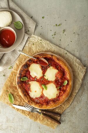Pizza Margherita served with mozzarella cheese, tomato sauce and fresh basilの写真素材