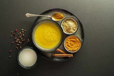 Healthy drink with curcuma and milk. Golden Milk, made with turmeric and other spicesの写真素材