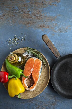 Cooking healthy meal with salmon steak and vegetables. Healthy cooking conceptの写真素材