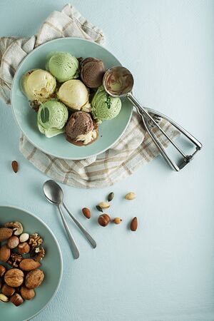 Set of soft ice cream scoops of different flavours with chocolate and nuts の写真素材
