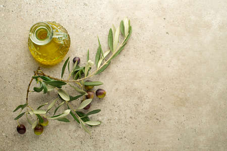 Olive oil and Branch with olives and leaves background close up. Healthy olive oil conceptの写真素材