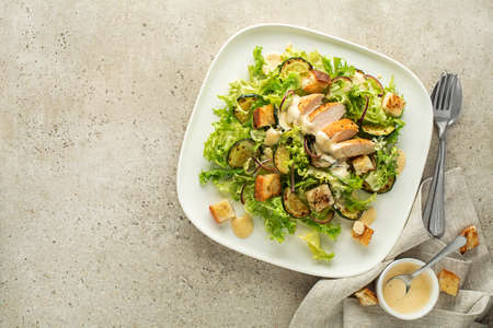 Chicken Salad. Chicken Caesar Salad. Caesar Salad with grilled chicken and croutons. Grilled chicken breast and fresh green salad close upの写真素材