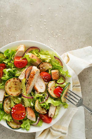 Healthy salad meal with grilled chicken and vegetables close up. Healthy lunch bowl.の写真素材