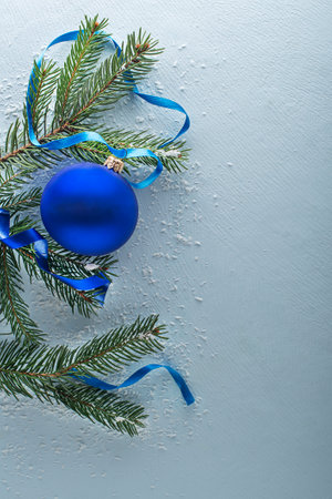 Christmas blue winter background with fir tree and decor. Top view with copy spaceの写真素材