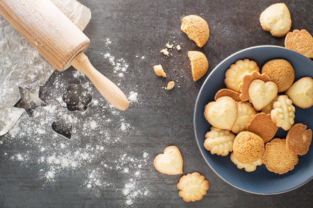 Making and baking cut-out sugar cookies of all shapes and sizes. Holiday, celebration and cooking concept.の写真素材
