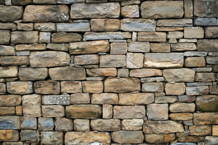 Texture of a stone wall. Old castle stone wall texture background. Stone wall as a background or texture. Part of a stone wall, for background or textureの写真素材