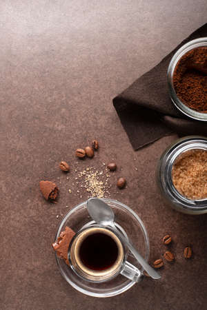 Cup of espresso coffee with ingredients on dark tableの写真素材