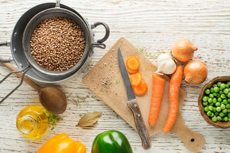 Ingredients for cooking fresh buckwheat porridge meal on wooden backgroundの写真素材