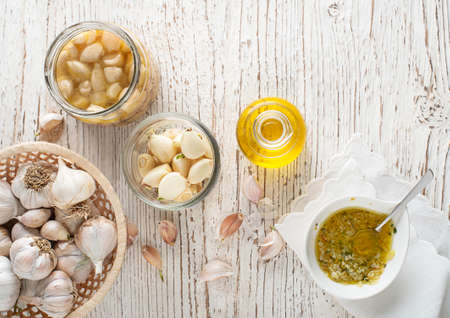 Garlic aromatic flavored oil or infusion bottle and garlic cloves. Garlic cookingの写真素材