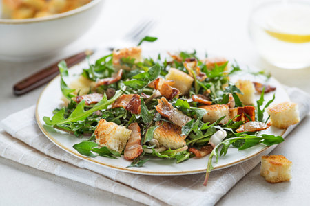 Dandelion salad with roasted bacon and croutons on grey background close upの写真素材