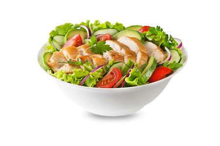 Healthy green salad with chicken breast avocado and fresh vegetables isolated on white backgroundの写真素材