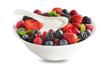 Bowl of healthy fresh berry fruit with cream isolated on white background. Berries colorful assorted mix of strawberry, blueberry, raspberry, blackberry, red currantの写真素材