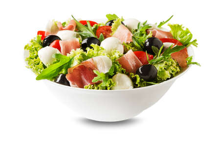 Healthy green salad with prosciutto, mozzarella and vegetables isolated on white backgroundの写真素材