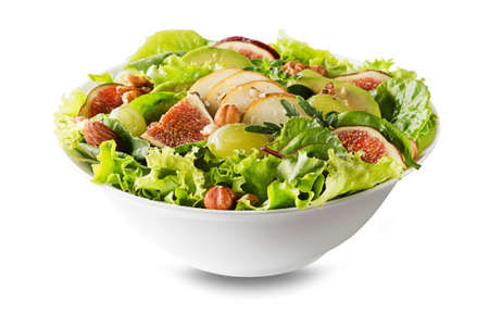 Fresh green leafy salad with fruits and nuts isolated on white background. Concept for a tasty and healthy mealの写真素材