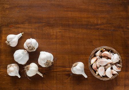 Garlic cloves on wooden vintage background.の写真素材