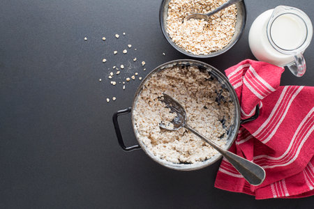 Oatmeal bowl. Cooked oatmeal served with fresh milk. Healthy food, diet. Top view.
