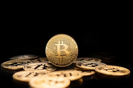 Bitcoin and cryptocurrency investing concept. Bitcoin cryptocurrency symbol with coins on black background. Trading on the cryptocurrency exchange. Trends in bitcoin exchange ratesの写真素材
