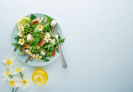 Spring salad with dandelion, asparagus, wild garlic, flowers, nettle and cheese. Healthy food for spring detoxの写真素材