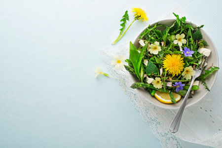Spring salad with dandelion, asparagus, wild garlic, flowers, nettle and cream cheese. Healthy spring detox food ingredients.の写真素材