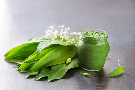 Fresh ramson or wild garlic pesto in glass jar close up. Healthy spring food conceptの写真素材