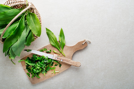 Making meal with Fresh ramson or wild garlic leaves. Healthy spring food conceptの写真素材