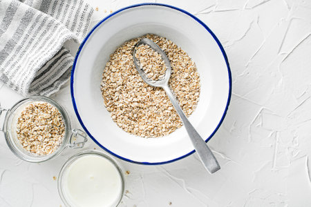 Oatmeal plate. Oatmeal served with fresh milk. Healthy food, diet. Top view.の写真素材