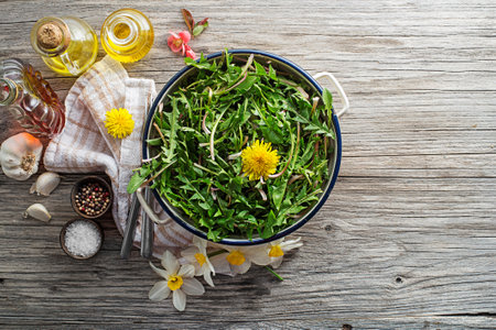 Fresh dandelion salad with dressing. Healthy spring food conceptの写真素材