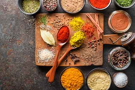 Colorful herbs and spices for cooking meal. Indian and Asian spices On grey stone background. Top view.の写真素材