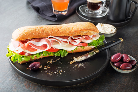 Breakfast served with coffee, juice, sandwich with ham, cheese, tomato and lettuce. Continental delicious healthy breakfast tableの写真素材