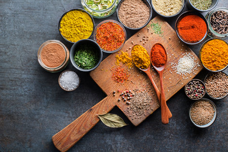 Colorful herbs and spices for cooking meal. Indian and Asian spices On grey stone background. Top view.の写真素材