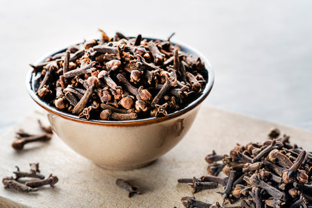 Cloves spice. Some dried cloves on grey background spice concept close up