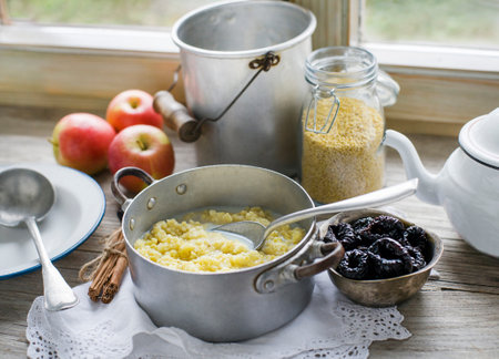 Millet Porridge with milk, prunes and Cinnamon, Tasty traditional Slovenian Breakfastの写真素材