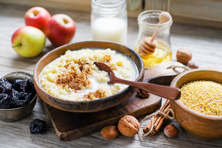 Millet Porridge with milk, prunes and Cinnamon, Tasty traditional Slovenian Breakfastの写真素材