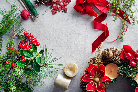 Making Advent wreath from natural branches of spruce, pine and ornaments. Decorations for christmas wreath at homeの写真素材