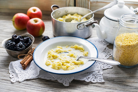 Millet Porridge with milk, prunes and Cinnamon, Tasty traditional Slovenian Breakfastの写真素材