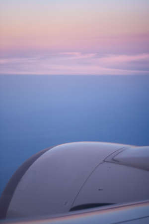 Beginning of new day. Early sunrise from airplane window.の写真素材