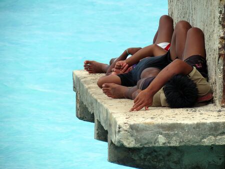 Three tired andamanese fishermen resting at a jetty.のeditorial素材