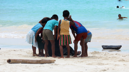 Children standing around a photographer and having a look at their photos, Andaman and Nicobar Islands, India, Asia.のeditorial素材