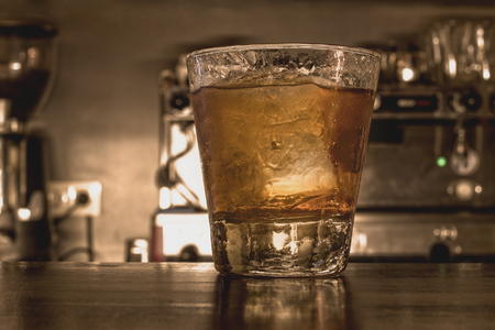 A glass of whiskey with ice in the bar.の写真素材
