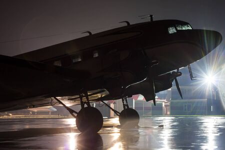 Retro plane on the rainy night at the airportのeditorial素材