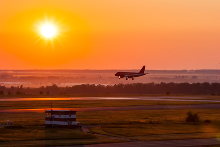 Landing airplane in the morning crimsonの写真素材