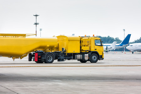 Yellow tank truck aircraft refueler at the airport apronの写真素材