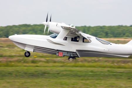 Amphibian airplane landing on the grass field