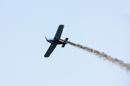 A small sports plane is burning in the airの写真素材