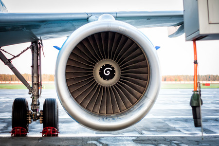 Close-up of engine and main landing gear of passenger airplaneの写真素材