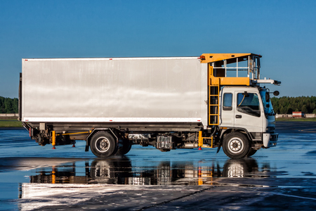 Airport catering truck with reflection in a puddleの写真素材